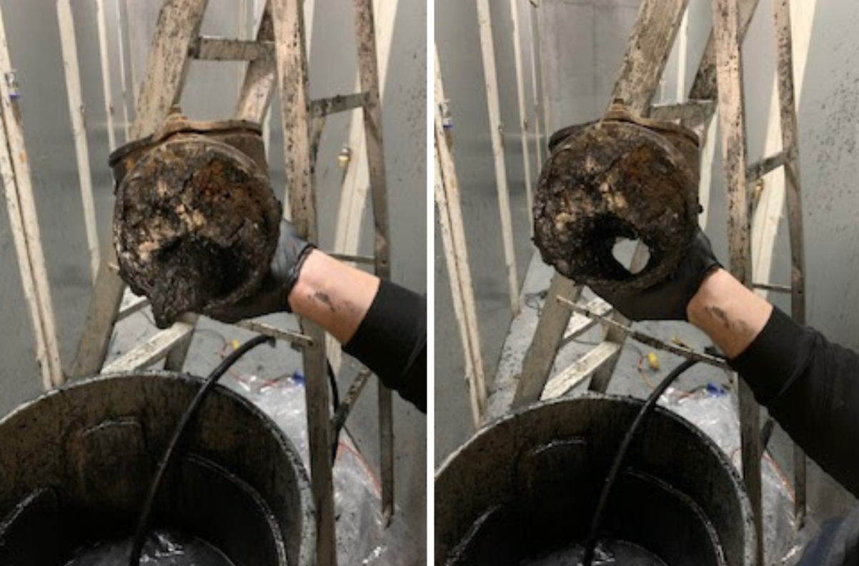 Hand holding clogged pipe before cleaning